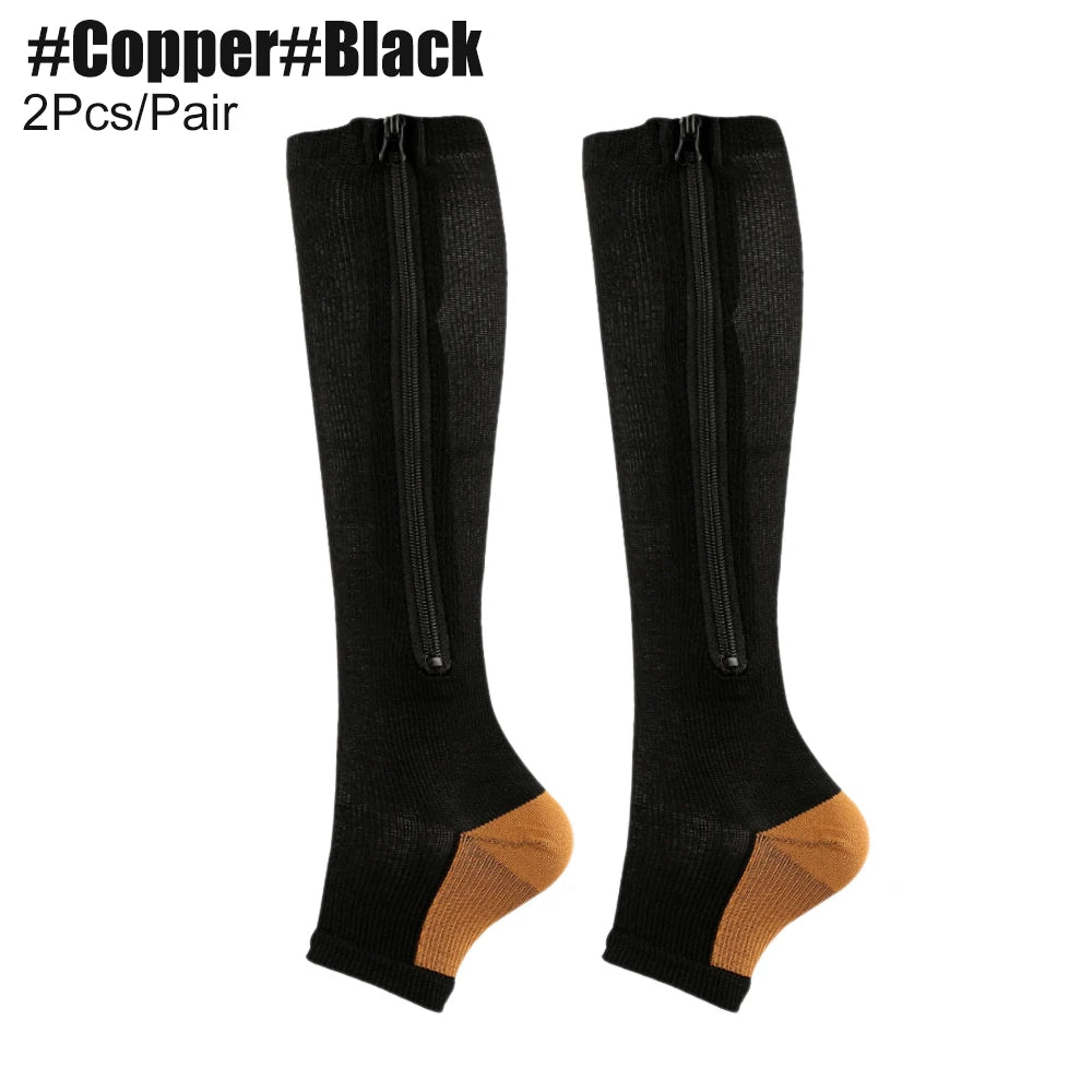 Black knee-high compression socks with gold toes and heels on a white background