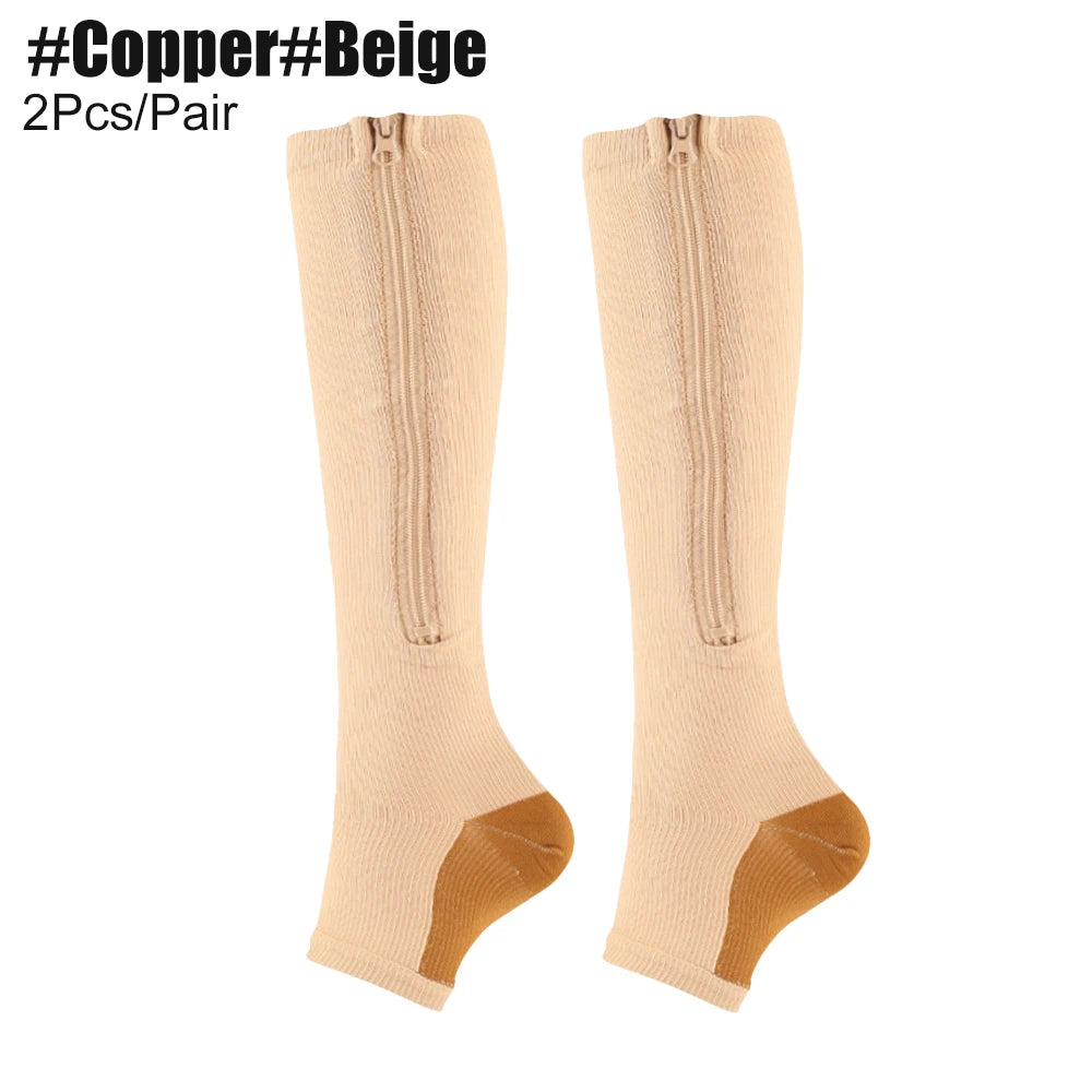 Beige knee-high compression socks with gold accents on a white background