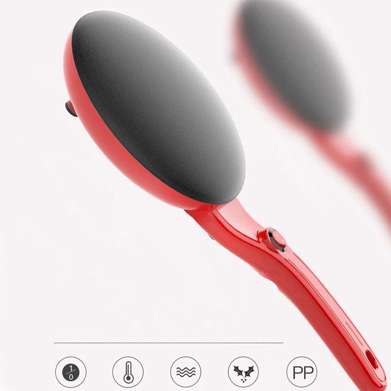 Red crepe maker with black paddle on a white background
